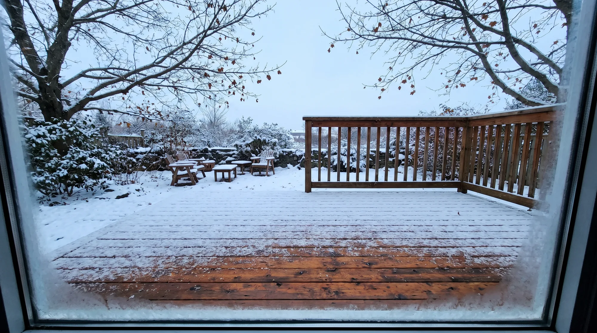 Cedar deck under light snow in winter